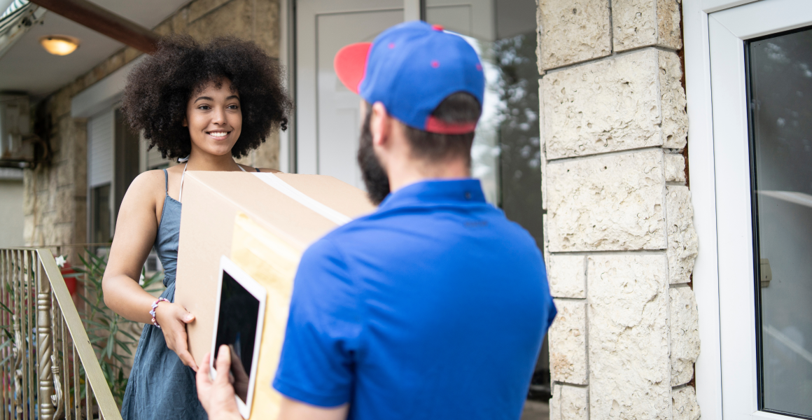 Delivery driver handing a package to a smiling customer at a pickup point, symbolizing convenience and trust in the last mile experience.