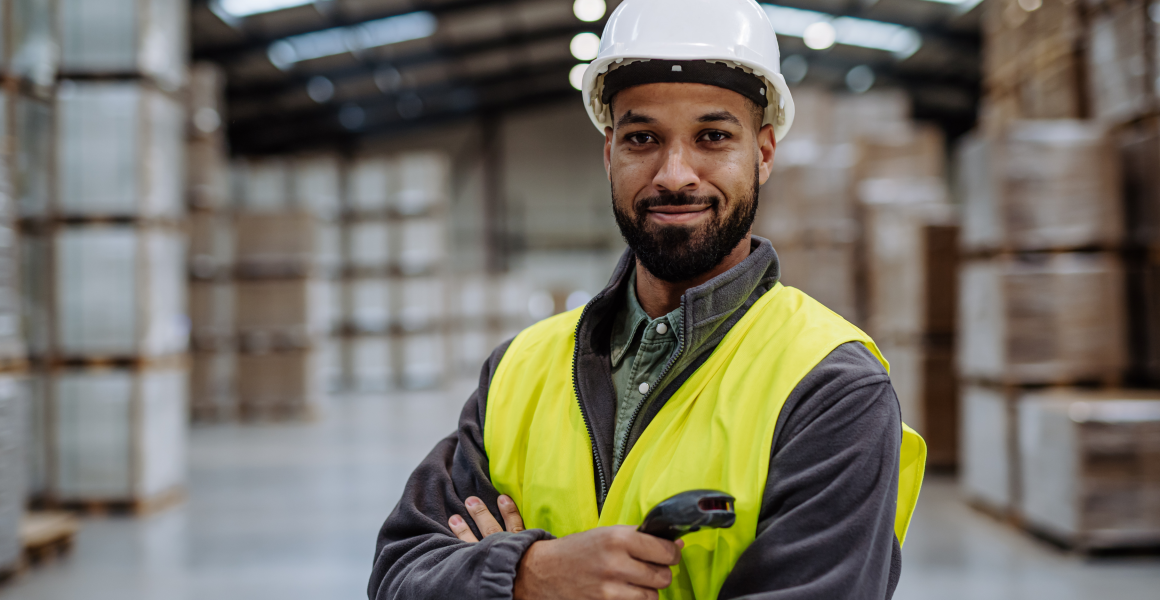 Organised SME warehouse with numbered shelves and employees performing inventory count.