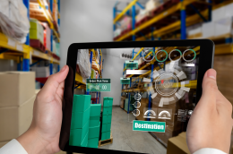 Warehouse manager using WMS software on a laptop to control inventory and logistics operations.