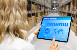 SME team using digital tools in a logistics and office environment, with laptops and tablets, representing accessible digitalisation and operational efficiency.